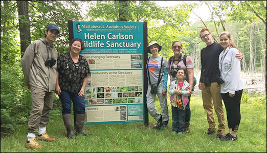 Group at bog by sign